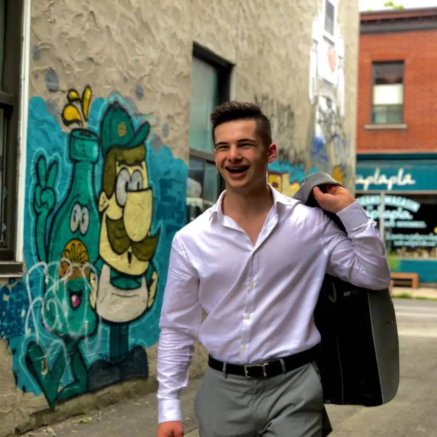 Antoine Robillard, fondateur de Robiii, souriant devant une murale colorée
