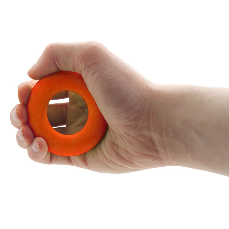 Beigne thérapeutique orange (ferme) pressé dans la main